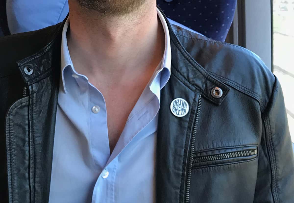 Photo showing a leather jacket with a Drinksmith enamel pin attached